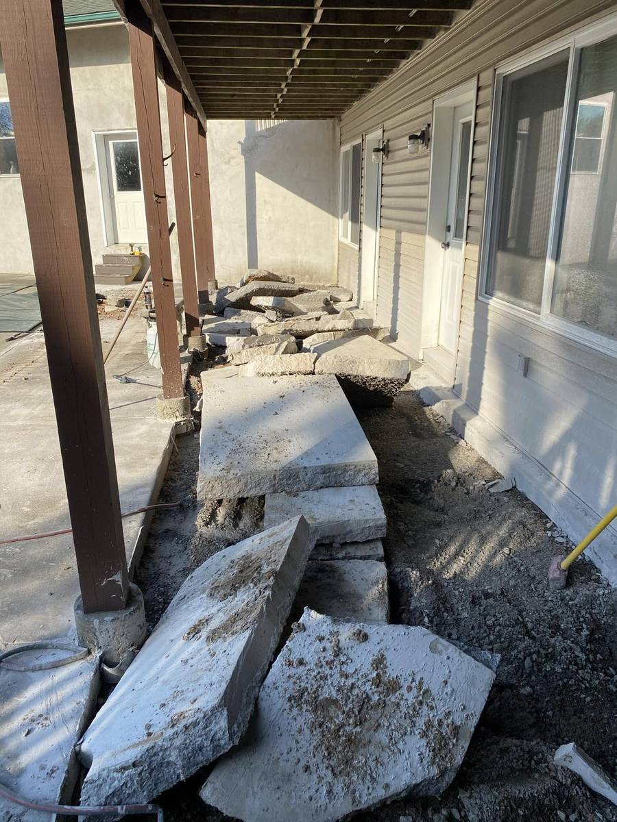 Old concrete walkway broken out into slabs ready for removal